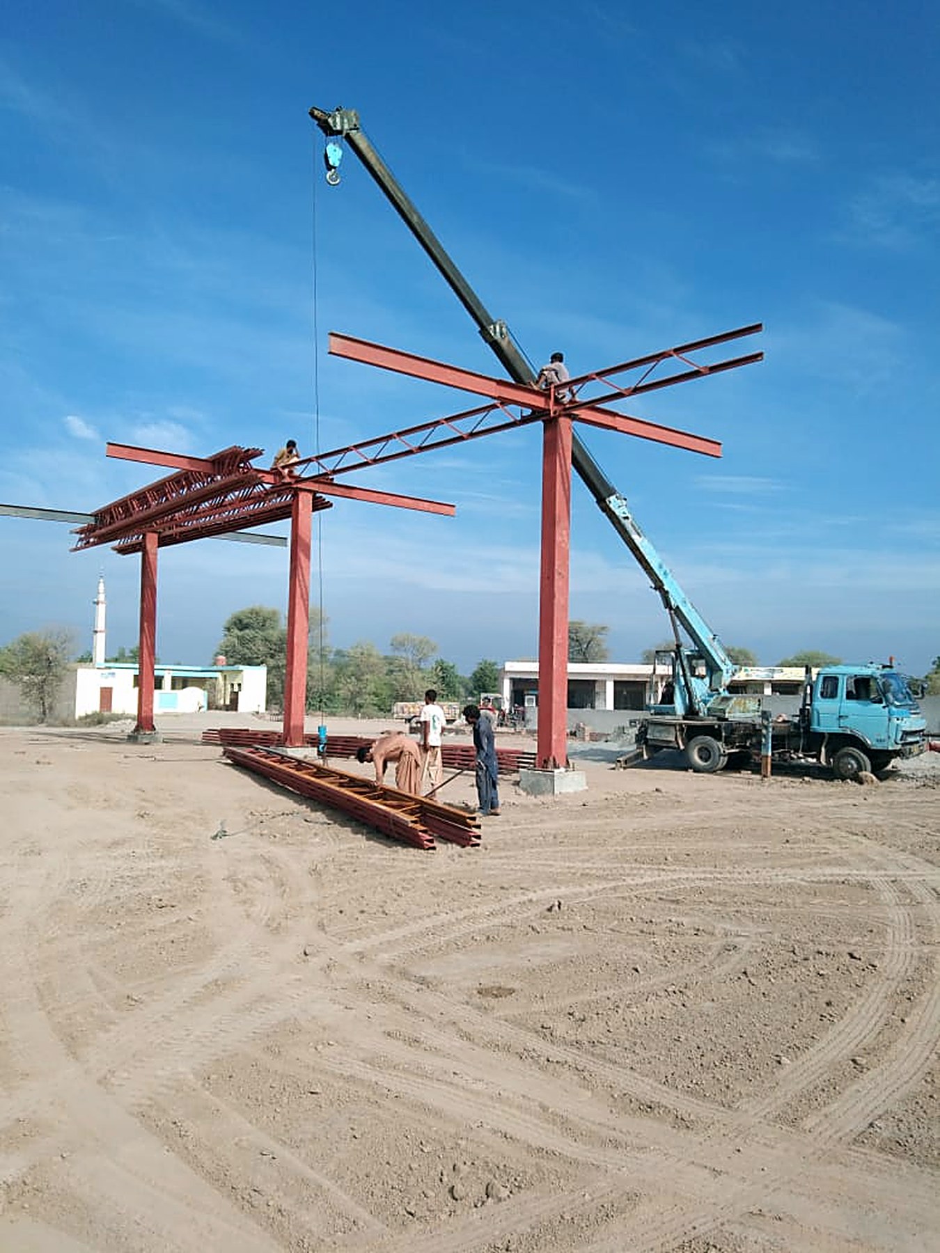 Fuel station canopy steel being erected by crane